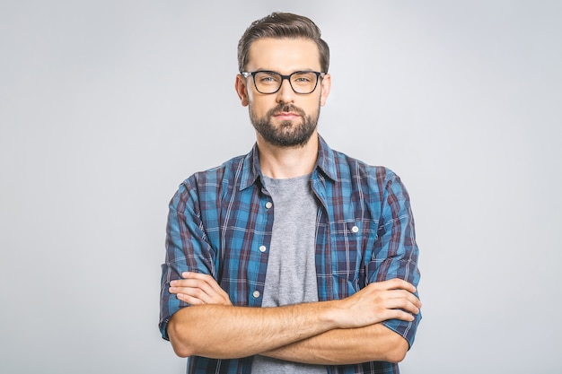 happy-young-man-portrait-handsome-young-man-casual-shirt-keeping-arms-crossed-smiling-while-standing-against-grey-wall_255757-72